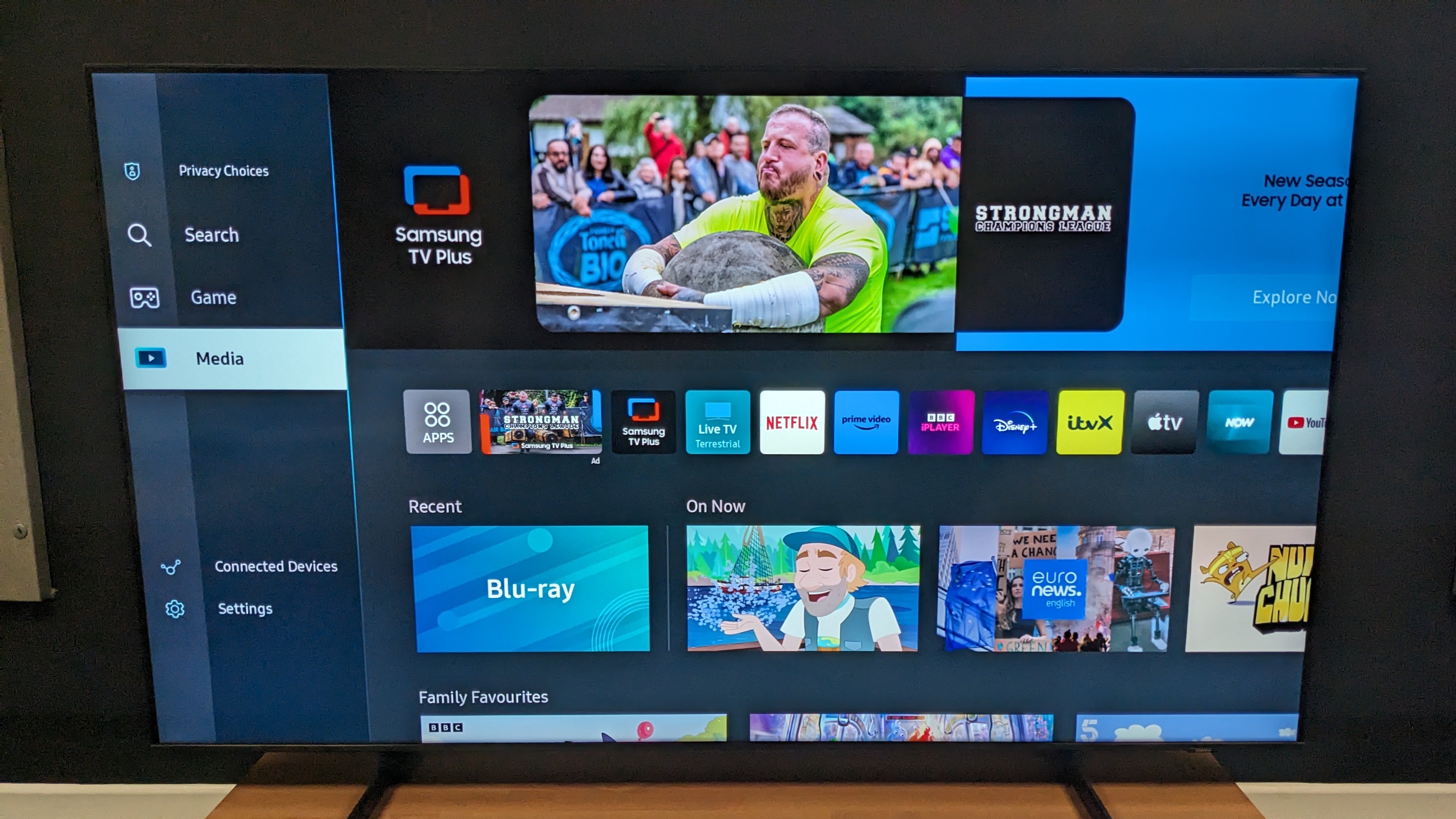 Samsung Cu8000 with Tizen Smart Hub home menu on screen