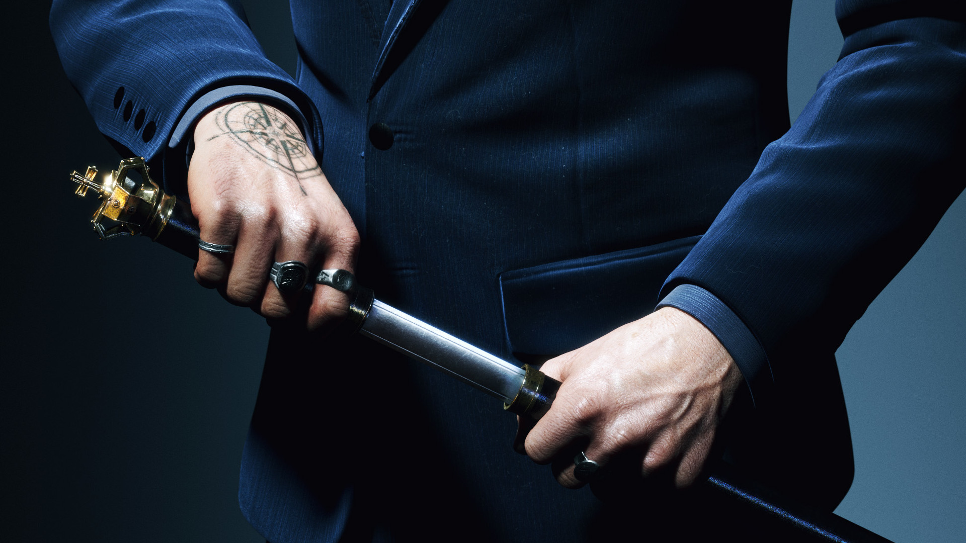 Galeb Bazory, a vampire in a crisp blue suit, draws a blade, in key art for Vampire: The Masquerade - Swansong