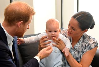 Prince Harry and Meghan Markle holding Prince Archie