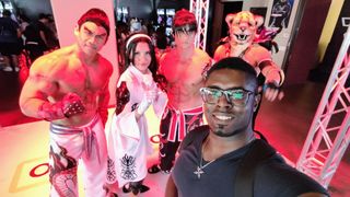 Derrek Lee taking a selfie at Comic-Con with people dressed as Tekken characters