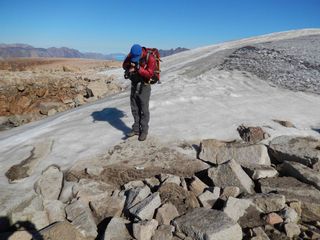 Doctoral student Simon Pendleton documents a sample site near the edge of an ice cap on Baffin Island.