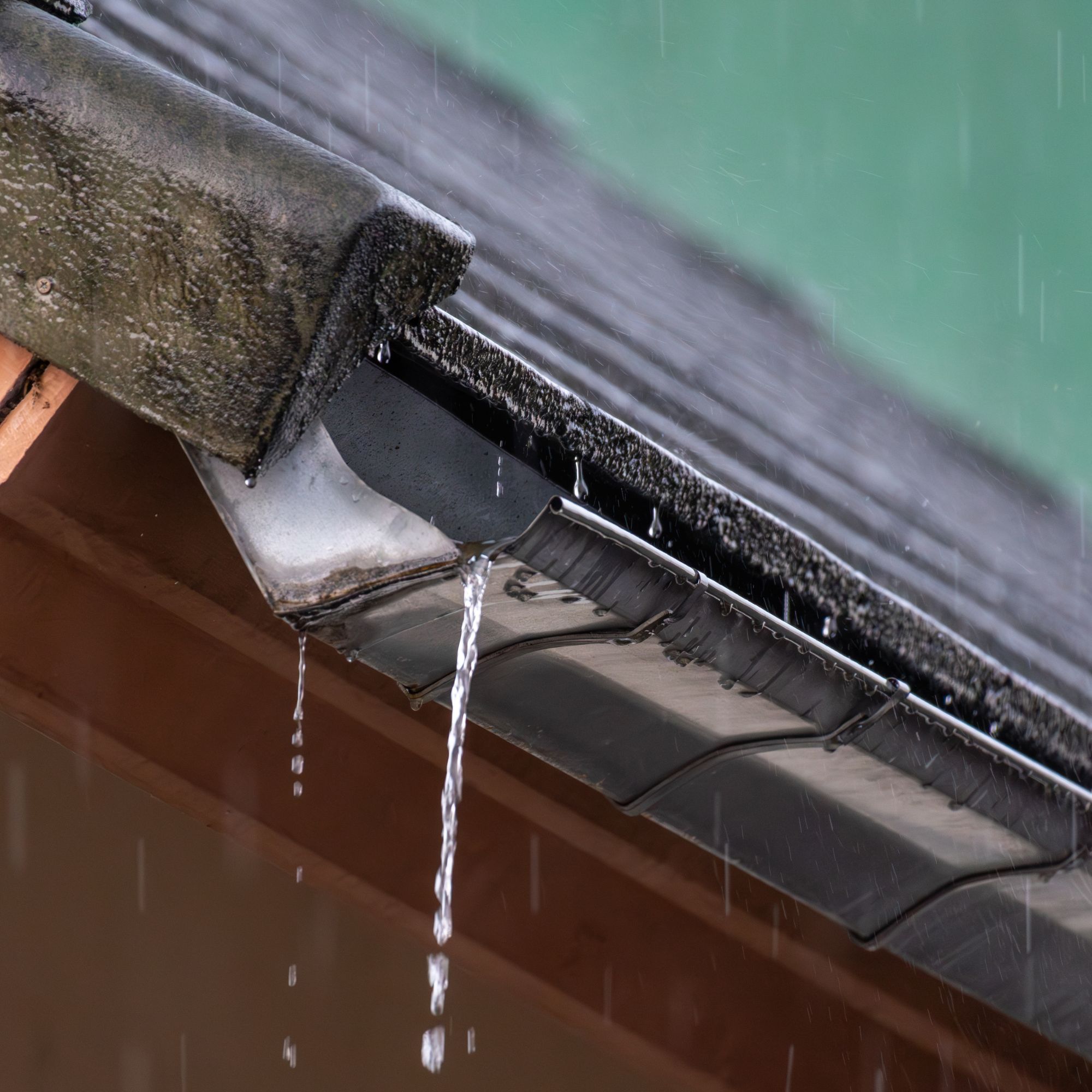 Water leaking from house guttering during heavy rain