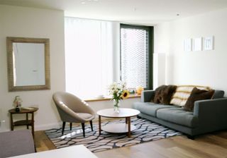 living room with white walls and a mid century vibe