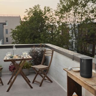 Sonos Move portable speaker on an outdoor balcony at dusk