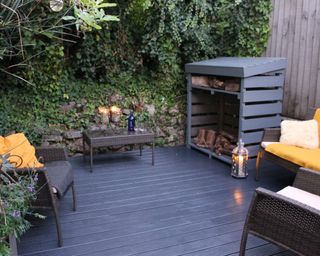 A backyard deck area painted gray