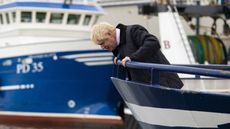 Boris Johnson looks to the water from a fishing trawler during a visit to Peterhead. 