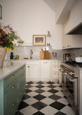 Traditional style, large kitchen, with black and white check floor, white cabinets and a blue kitchen island