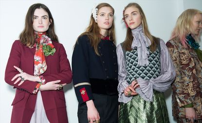 Female models wearing navy, burgundy, grey and floral clothes from the A/W 2015 collection
