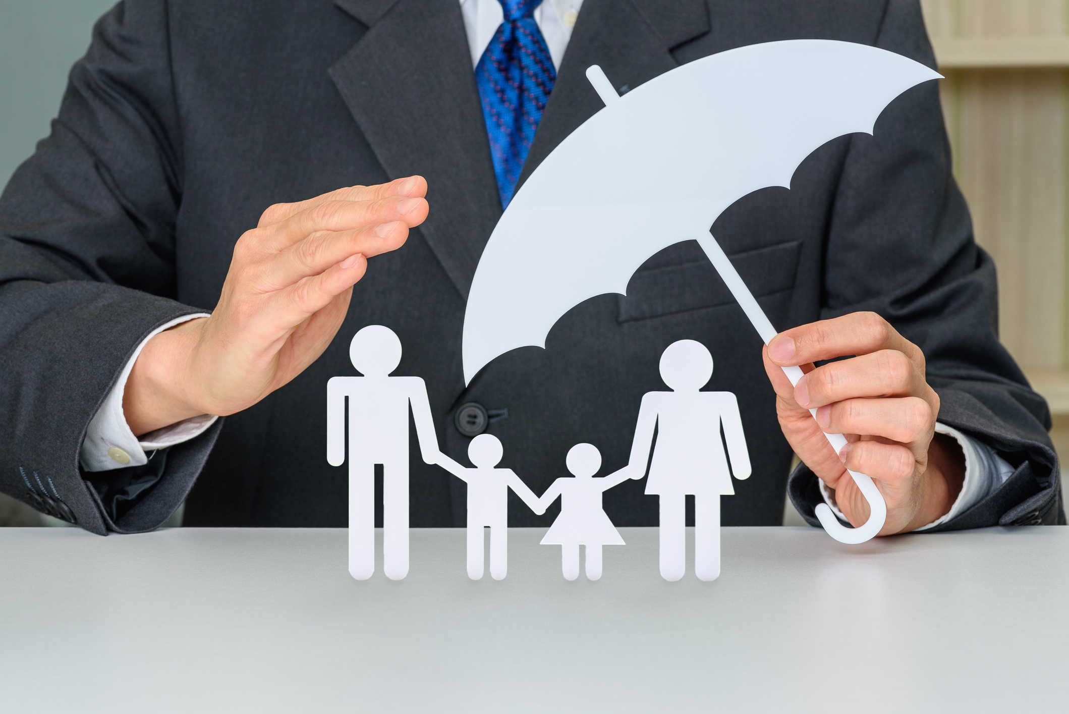 Man covering symbols of family with an umbrella. 