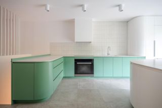 Quesnel Apartment by naturehumaine - a green L shaped kitchen.