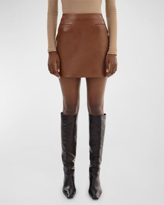 a model wears a brown leather mini skirt