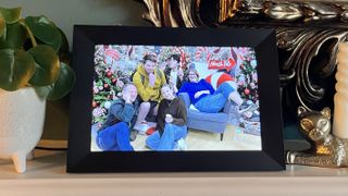 Aeezo 10.1-inch digital picture frame on mantelpiece displaying group portrait