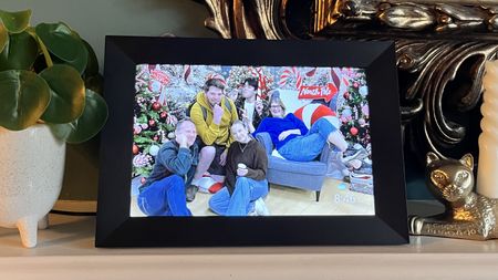 Aeezo 10.1-inch digital picture frame on mantelpiece displaying group portrait