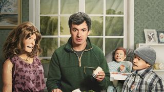 Nathan Fielder with dolls at a dinner table in key art for The Rehearsal