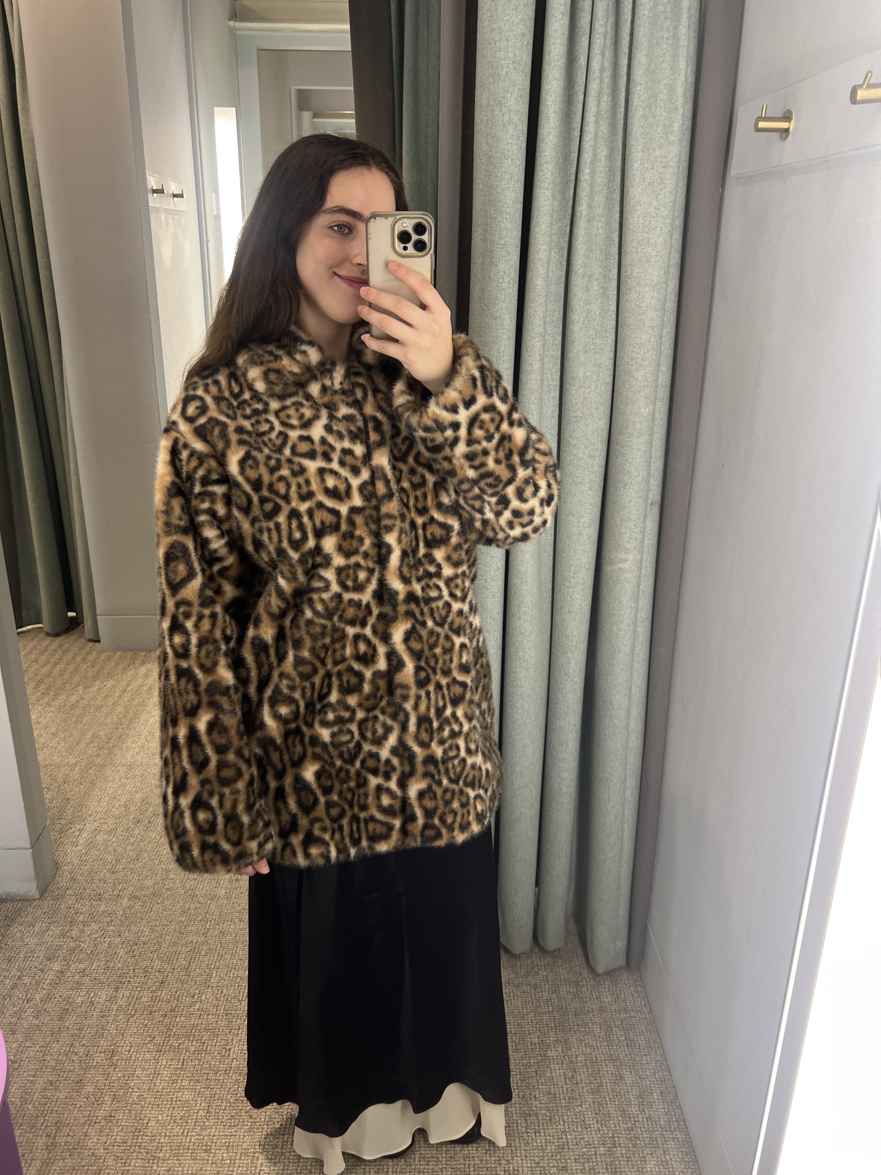 An image of Who What Wear UK's SEO Writer Ava Gilchrist wearing a satin skirt from Reformation with a leopard print coat.