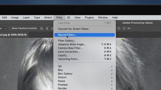 A laptop screen showing a Photoshop menu