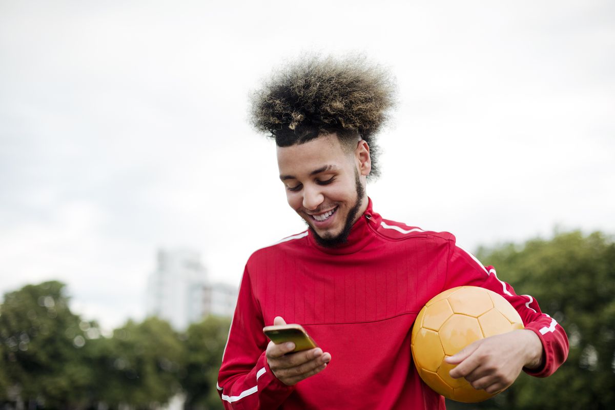 Man smiling at smartphone