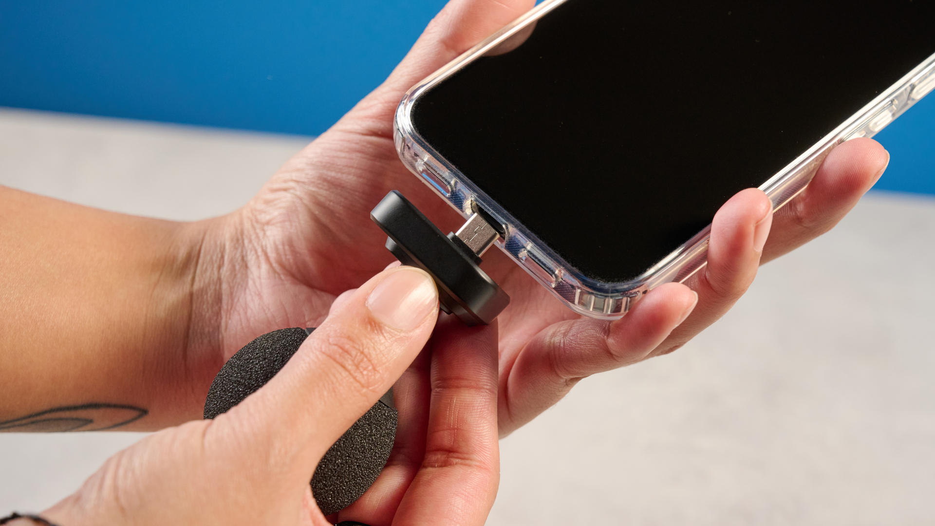 the shure mv88 usb-c microphone photographed against a blue tom's guide background and shown connected to a google pixel 10 pro