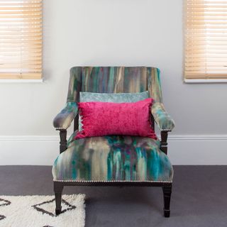 living room with white wall and wooden arm chair