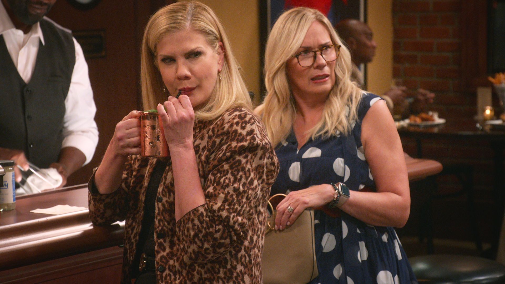 Kristen Johnson and Leanne Morgan turn around at a bar in disgust