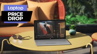 HP envy 360 laptop on a yellow table outdoors