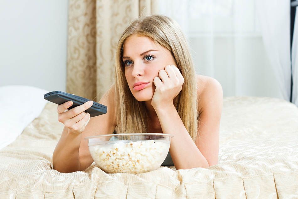 bored woman watching TV