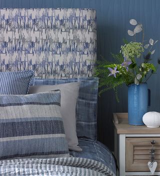 blue bedroom with upholstered headboard