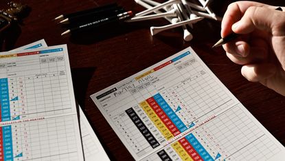 A player signing a golf scorecard