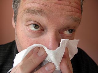 A man blows his nose.