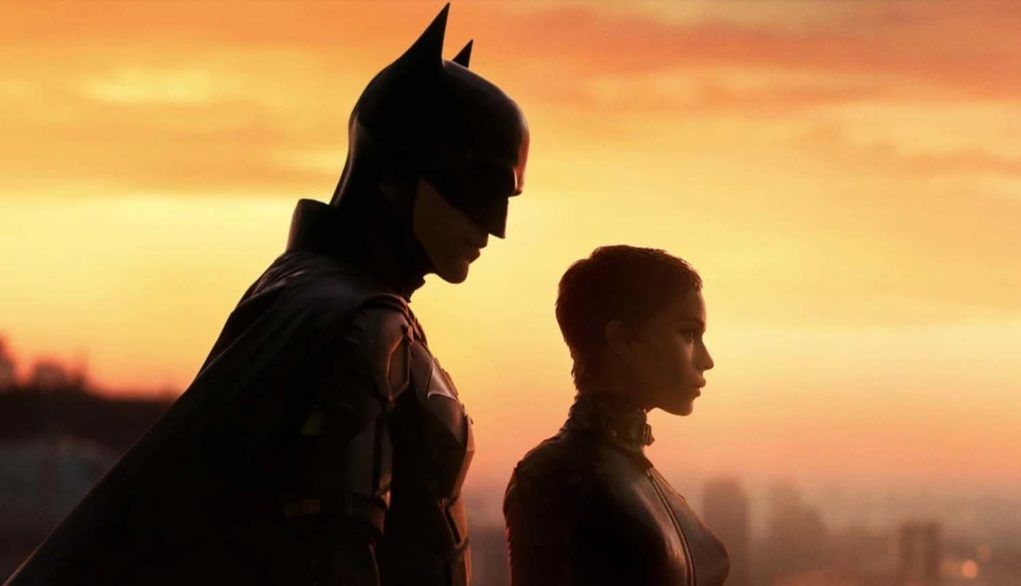 The Dark Knight and Catwoman look out over Gotham City in The Batman