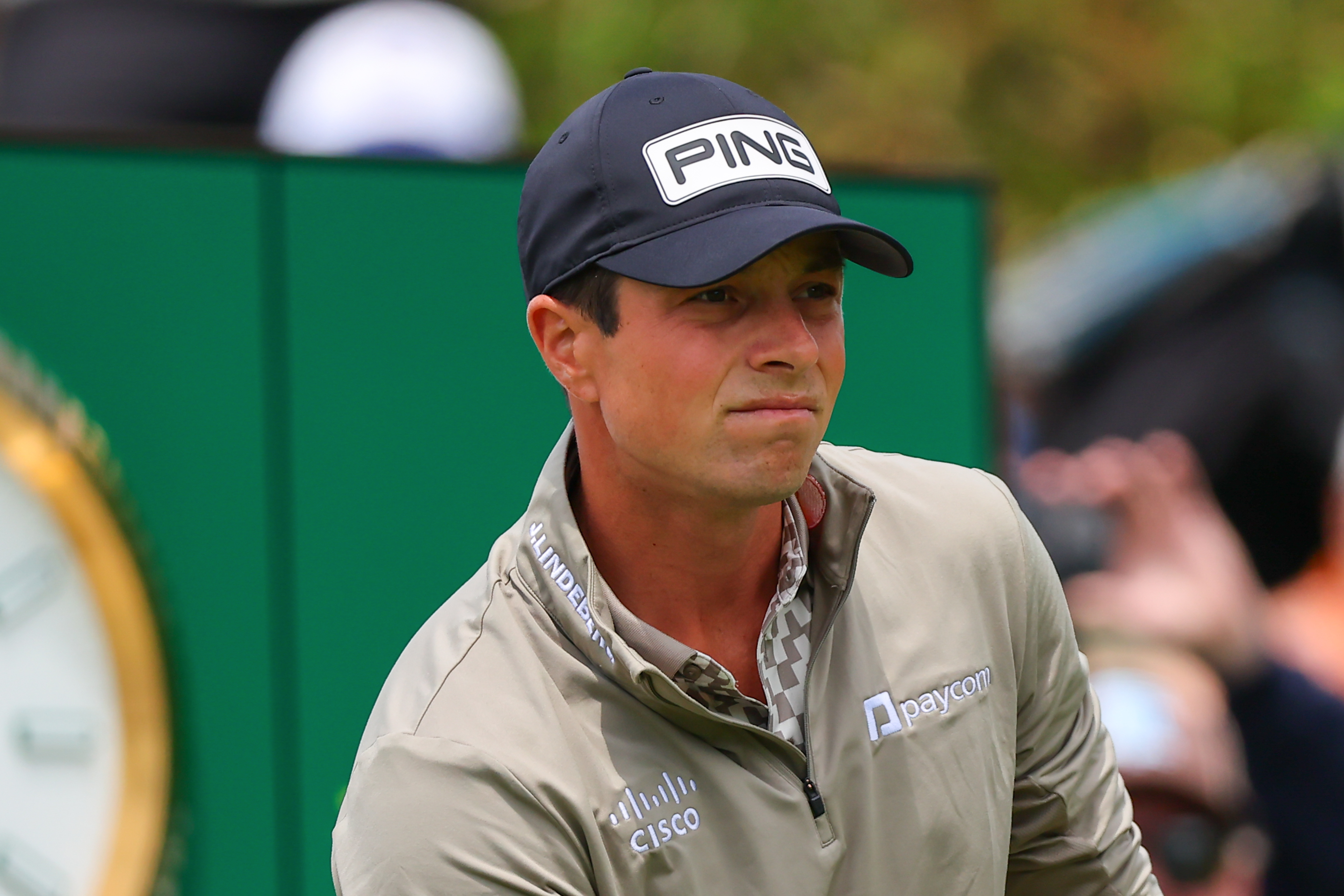 Viktor Hovland watches his drive at the 2026 PGA Championship in front of a green Rolex board