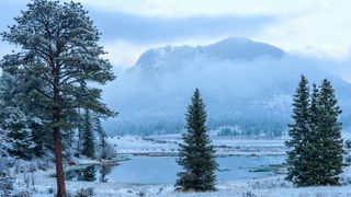 A snowy Spring evening view of Sheep Lakes, with foggy Deer Mountain standing in background