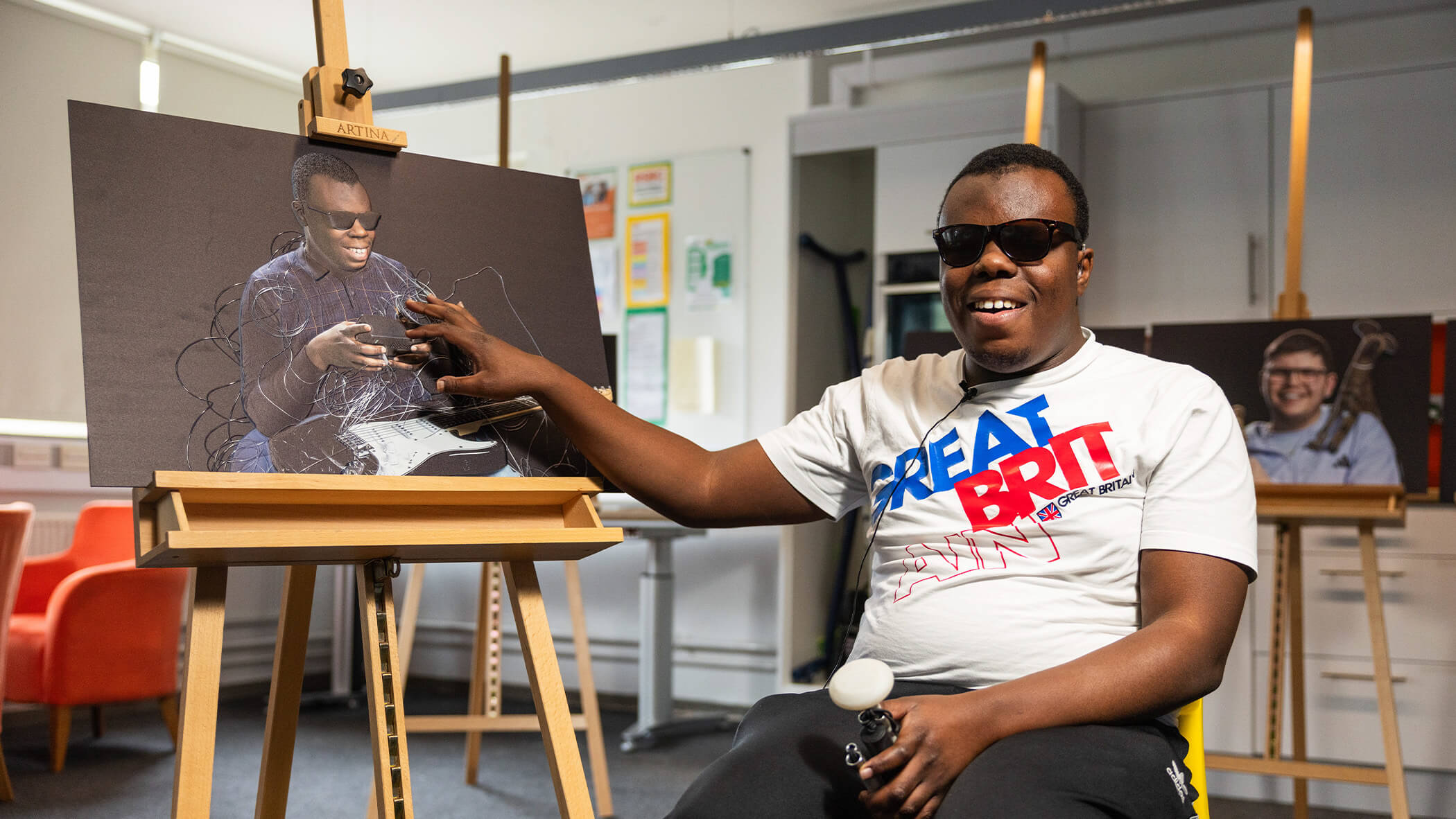 Student shows off painting they created. 