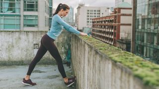 A woman stretching in workout clothes