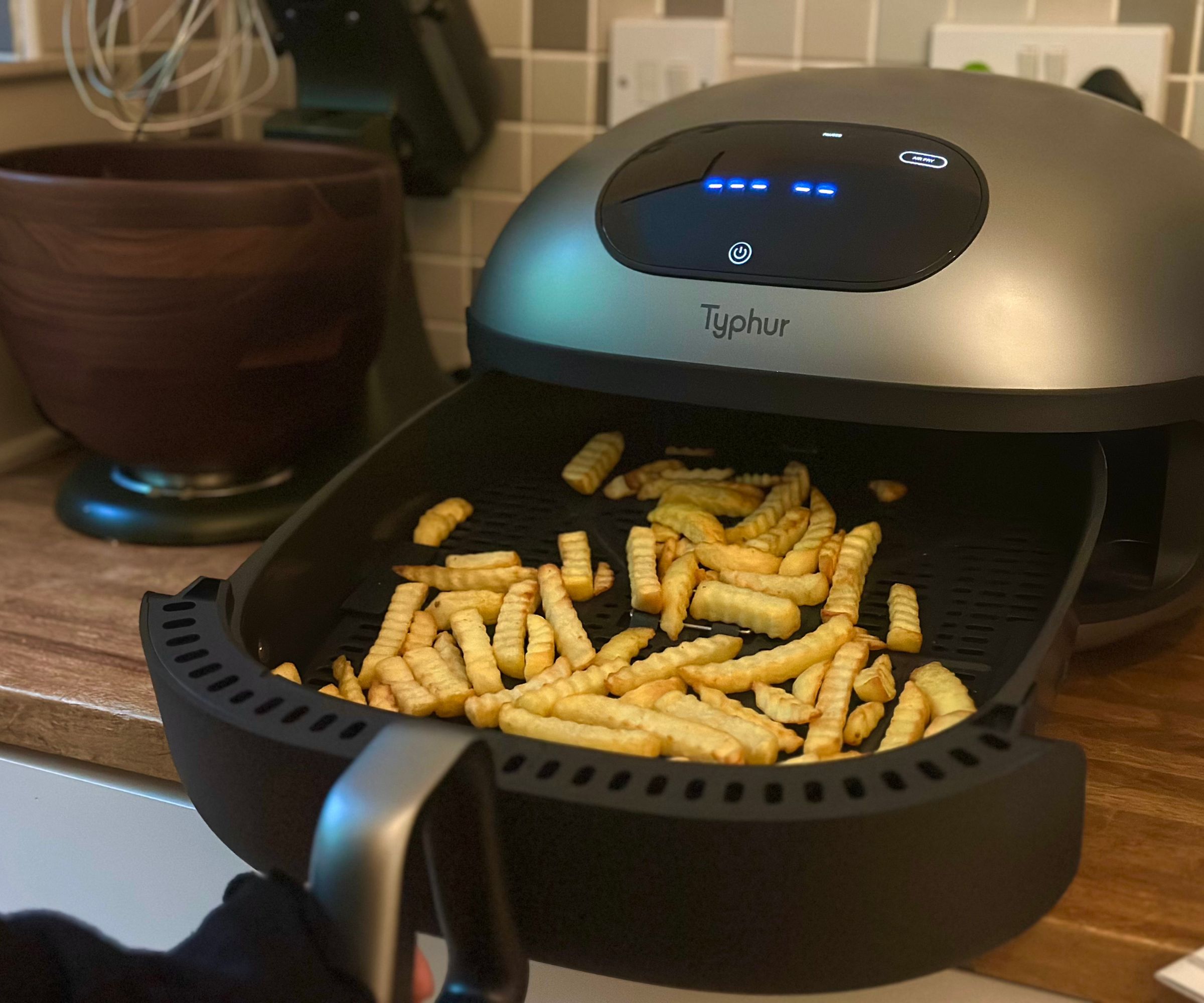 The Typhur Dome air fryer making crinkle cut fries in my kitchen