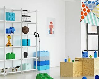 White playroom with open shelves and large Lego-shaped stackable boxes on the far back left