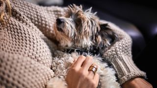 Woman cuddling her dog