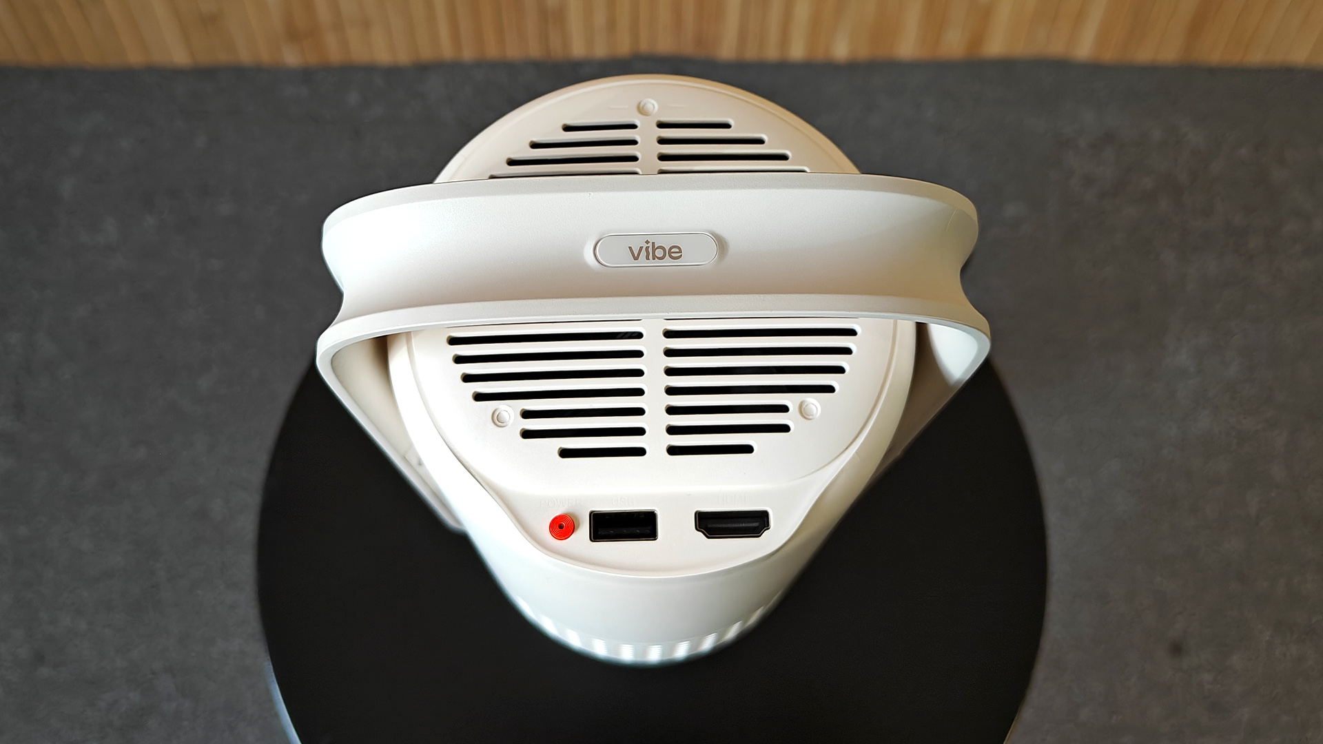 Xgimi Vibe One portable projector viewed from top showing connections with 'vibe' seen on top of cradle