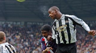 Newcastle upon Tyne, UNITED KINGDOM: Newcastle United's defender Titus Bramble (right) heads the ball clear from West Bromwich Albion's Nwankwo Kanu (blue shirt) as West Bromwich are defeated 2-0 in the English Premiership at St James Park, Newcastle 22 April 2006. AFP PHOTO/GLENN CAMPBELL Mobile and website use of domestic English football pictures subject to subscription of a license with Football Association Premier League (FAPL) tel : +44 207 298 1656. For newspapers where the football content of the printed and electronic versions are identical, no licence is necessary. (Photo credit should read GLENN CAMPBELL/AFP via Getty Images)