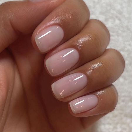 A close up of a pink manicure