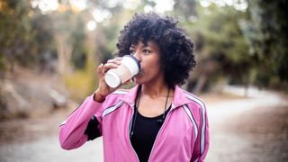 Woman walking with a cup of coffee