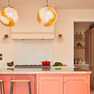 pink kitchen with globe glass pendant lights