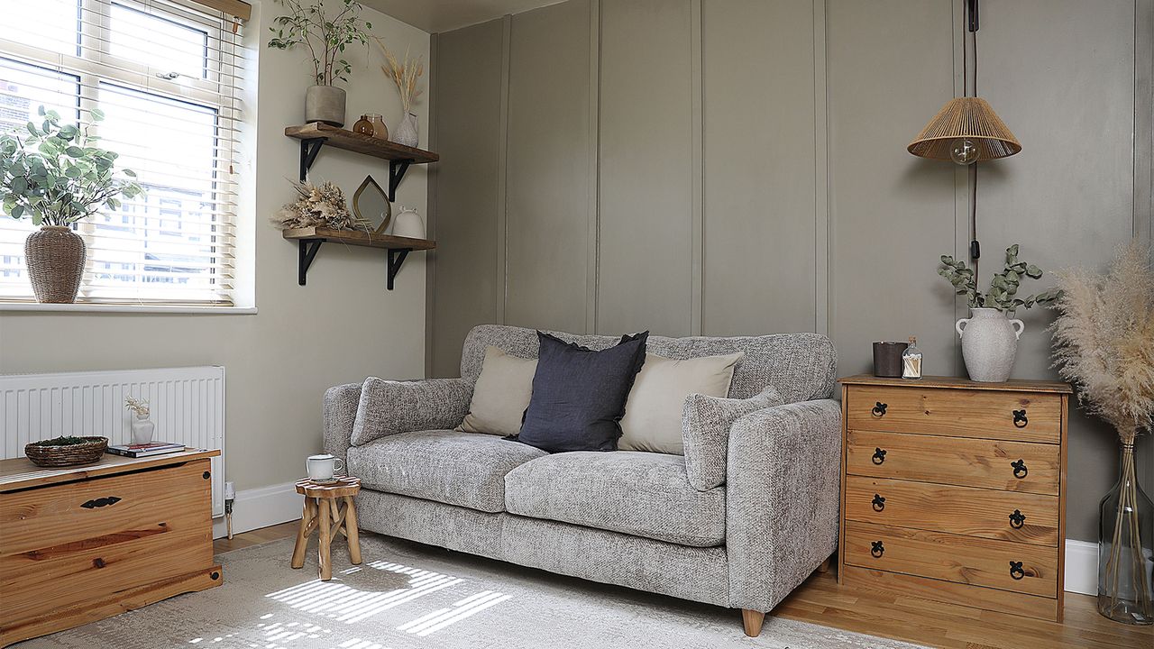 living room with wall panelling and neutral sofa