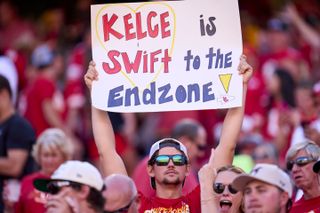 A fan holds a sign supporting Taylor Swift and Travis Kelce as the Kansas City Chiefs play the Chicago Bears