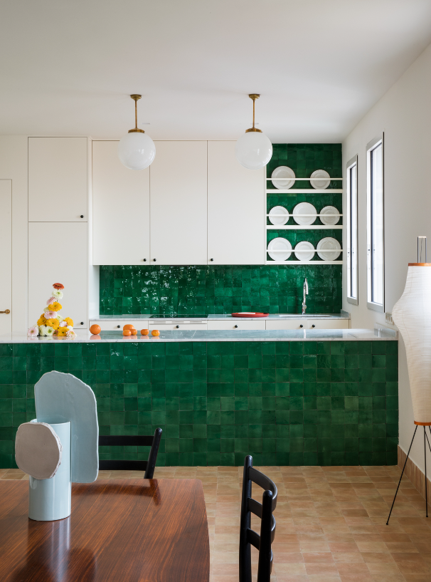 A kitchen island with zellige tiles