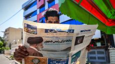 Iranian man reads newspaper on death of President Ebramin Raisi