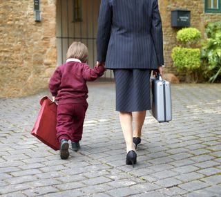 child going to school with parent