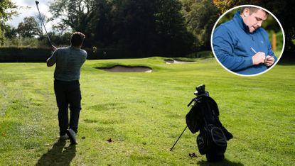 A golfer hits a wedge into the green, whilst another golfer marks a card