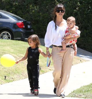 Mason Disick walking with mother Kourtney Kardashian.