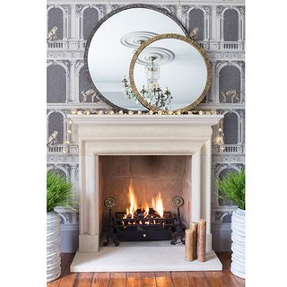 white fire place designed wall and round mirrors